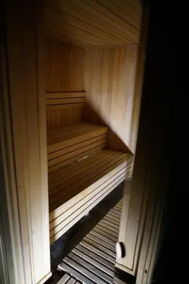 a small wooden bench in a small sauna at Premier 24 Milmari Kopaonik in Kopaonik