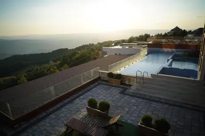 a house with a swimming pool on top of a mountain at Premier 24 Milmari Kopaonik in Kopaonik