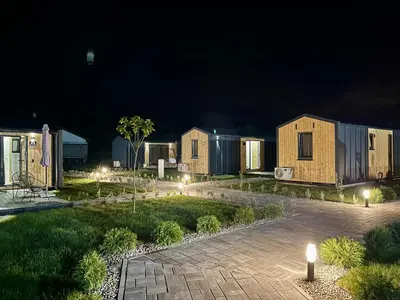 a row of houses at night with lights at Kapija Svrljiga in Svrljig