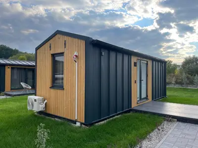 a tiny house with a black and wooden exterior at Kapija Svrljiga in Svrljig