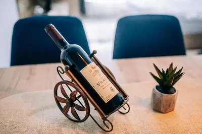 a bottle of wine sitting on top of a table at Šilja Kopaonik S45 Milmari in Kopaonik