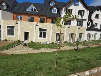 a large house with a lawn in front of it at Šilja Kopaonik S45 Milmari in Kopaonik