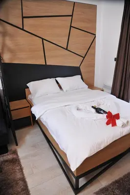 a bed with a red bow on top of it at Milmari boutique S3 lux in Kopaonik