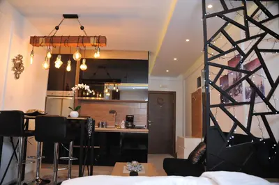a kitchen and a living room with a table at Milmari boutique S3 lux in Kopaonik