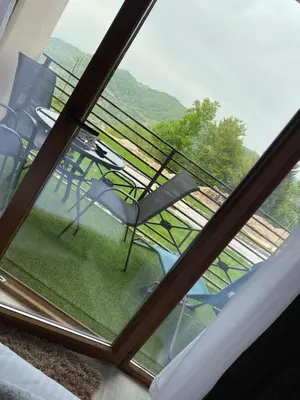 a view of a glass window with chairs on a balcony at Milmari boutique S3 lux in Kopaonik