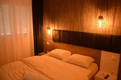 a bedroom with a bed with two white pillows at Amor in Vrnjačka Banja