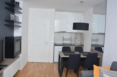 a kitchen and dining room with a table and chairs at Amor in Vrnjačka Banja
