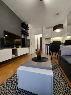 a living room with a couch and a table at Amor in Vrnjačka Banja