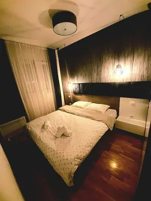 a bedroom with a bed with two books on it at Amor in Vrnjačka Banja