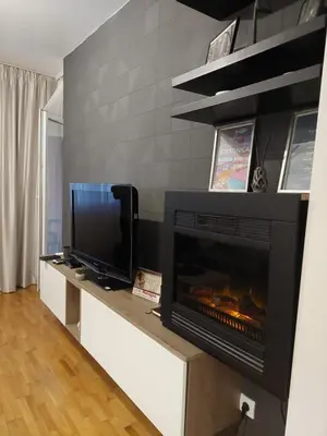 a living room with a television and a fireplace at Amor in Vrnjačka Banja