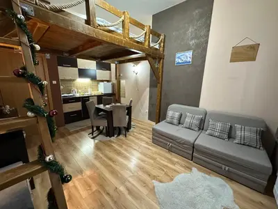 a living room with a couch and a table at Apartman Planinski raj in Kopaonik