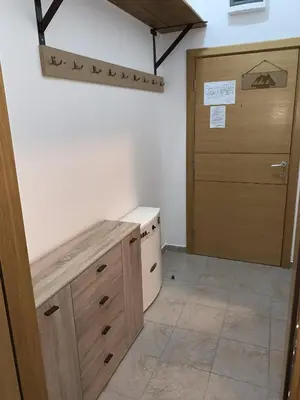 a room with a closet with a wooden door at Apartman Planinski raj in Kopaonik