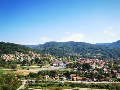 a small town in a valley with mountains at Motel Predejane in Predejane