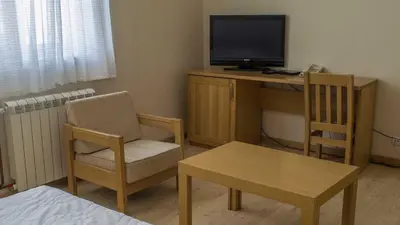 a room with a desk with a television and a chair at Motel Predejane in Predejane