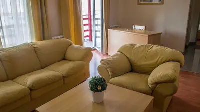 a living room with two couches and a table at Motel Predejane in Predejane