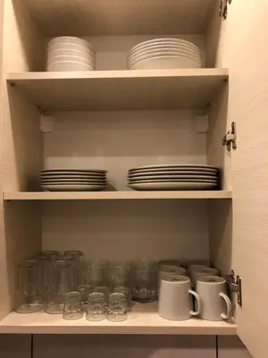 a cupboard with plates and dishes on it at K19 Milmari Resort & Spa in Kopaonik