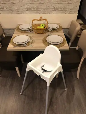 a table with plates and a basket of fruit on it at K19 Milmari Resort & Spa in Kopaonik