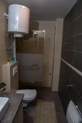 a bathroom with a toilet and a sink at K19 Milmari Resort & Spa in Kopaonik