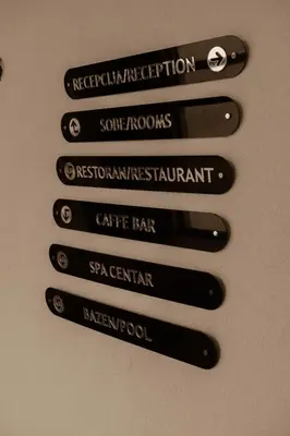a group of black signs on a wall at K19 Milmari Resort & Spa in Kopaonik