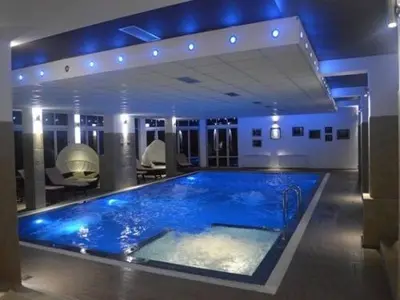 a large blue tub in a room with chairs at K19 Milmari Resort & Spa in Kopaonik