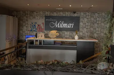 a kitchen with a counter and a sign on a wall at K19 Milmari Resort & Spa in Kopaonik