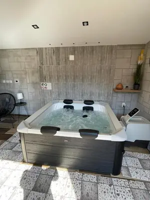 a large bath tub in a living room with at Aphrodite Hills Apartments-Stara Planina in Crni Vrh