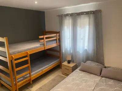 a bedroom with two bunk beds and a bed at Aphrodite Hills Apartments-Stara Planina in Crni Vrh
