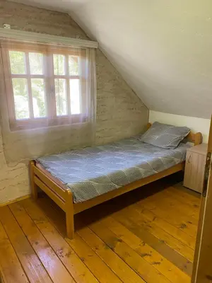 a bed sitting in a room with a window at Aphrodite Hills Apartments-Stara Planina in Crni Vrh
