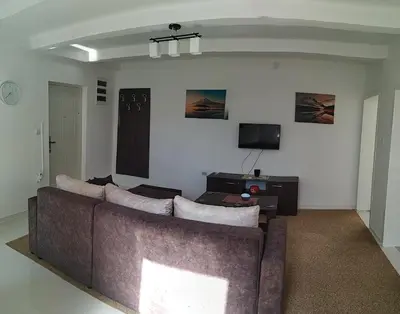 a living room with a couch and a tv at BC Apartments in Niš