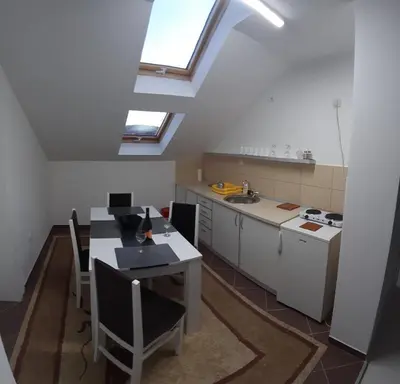 a kitchen with a table and a sink at BC Apartments in Niš
