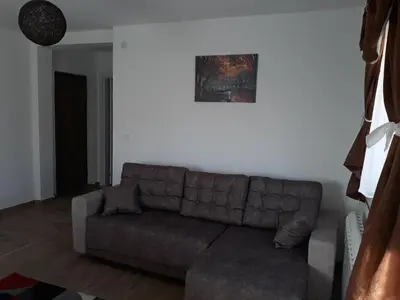 a living room with a couch and a picture on the wall at Iznad Oblaka1 Apartment PA-JO in Kopaonik