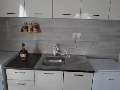 a kitchen counter with a sink and a stove at Iznad Oblaka1 Apartment PA-JO in Kopaonik