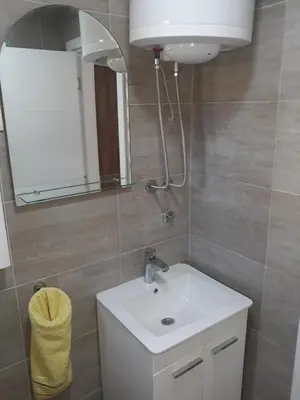 a bathroom with a white sink and a mirror at Iznad Oblaka1 Apartment PA-JO in Kopaonik