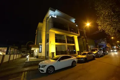a group of cars parked in front of a building at night at VIR Villa in Kruševac