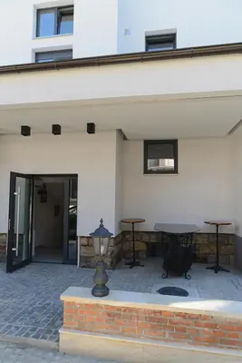 a patio with two tables and a building at VIR Villa in Kruševac