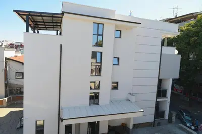 a white building with a balcony on top of it at VIR Villa in Kruševac