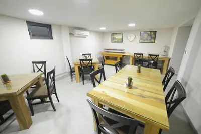 a dining room with wooden tables and chairs at VIR Villa in Kruševac