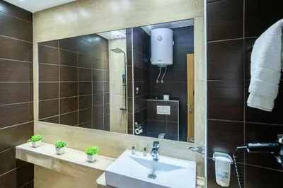 a bathroom with a sink and a mirror at Milmari Resort & Spa Suites in Kopaonik