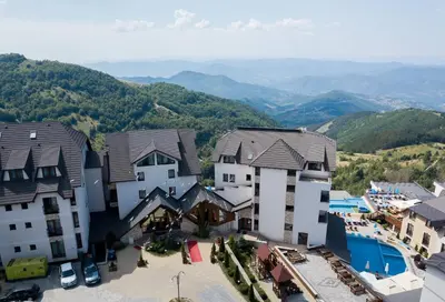 an aerial view of a town with mountains in the background at Milmari Resort & Spa Suites in Kopaonik