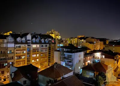a view of a city at night with buildings at Mirkovic Lux apartman in Niš