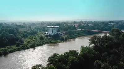 a large building on the side of a river at Plaža in Varvarin