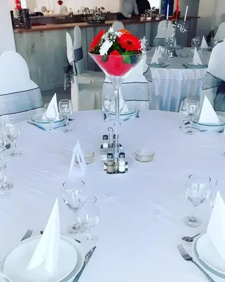 a white table with a vase of flowers on it at Plaža in Varvarin