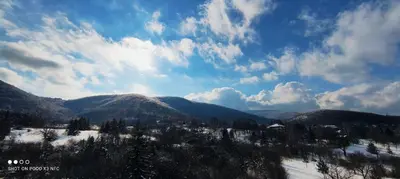 a view of a snowy mountain range with a blue sky at Sky Apartman in Soko Banja