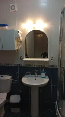 a bathroom with a sink and a toilet and a mirror at Sky Apartman in Soko Banja
