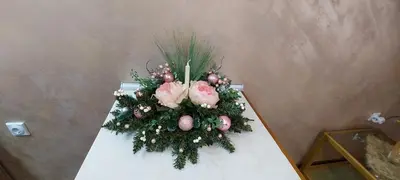 a white table with a flower arrangement on it at Apartmani Neca in Vrnjačka Banja