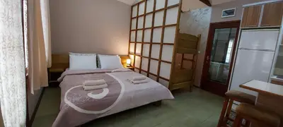 a bedroom with a bed with two towels on it at Apartmani Neca in Vrnjačka Banja