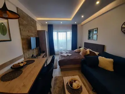 a room with a bed and a table and a couch at Kop Milmari P32 in Kopaonik