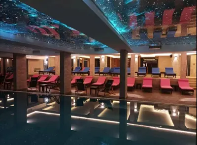 a hotel lobby with chairs and a pool at Kop Milmari P32 in Kopaonik