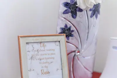 a picture frame with a sign in front of a vase at Apartman Saga Premium Garaza Parking Vauceri Ne in Soko Banja
