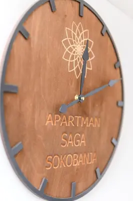a wooden clock with the name of saxaosaosa at Apartman Saga Premium Garaza Parking Vauceri Ne in Soko Banja